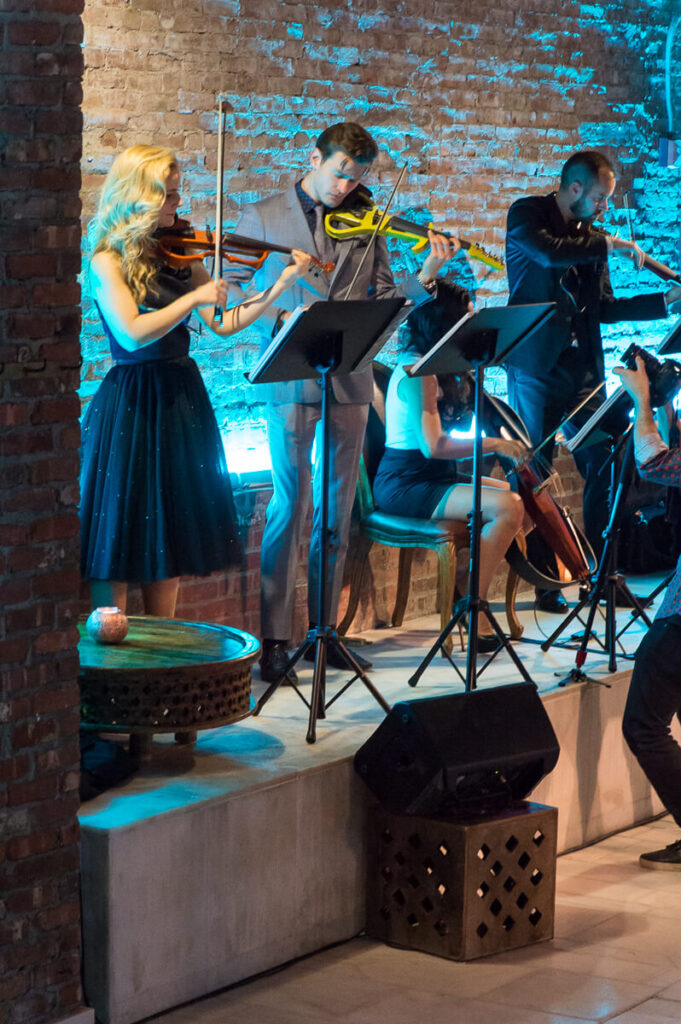 iral Artists electric string quartet performing at Aire Ancient Baths in NYC, wearing Ted Baker