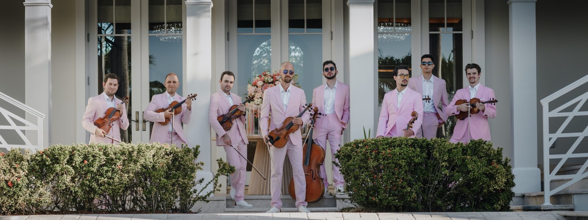 Kiral Artists Pop String Orchestra in pink suits after wedding reception in Palm Beach